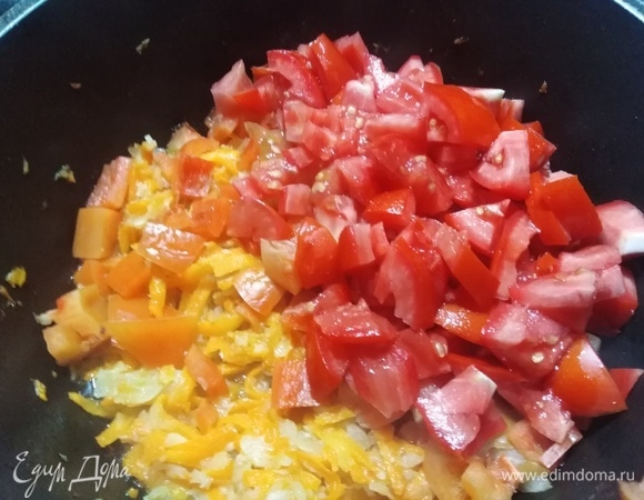 В сковороду к овощам добавить нарезанный болгарский перец с помидорами. Обжаривать овощи в течение 5–7 минут.
