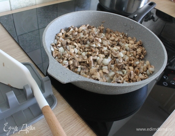 На сковороду налить немного растительного рафинированного масла, разогреть, выложить грибы одновременно с луком и на небольшом огне обжаривать почти до готовности. У всех по–разному, в зависимости от плиты, у меня ушло минут 10. Пока все обжаривается, выпарится жидкость из грибов, лук станет мягче.