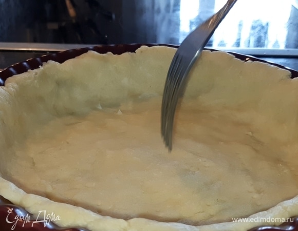 Тесто распределите по форме и вилкой сделайте по всей поверхности проколы до дна. Размер моей формы — 17 см в диаметре и 4 см — высота бортиков.