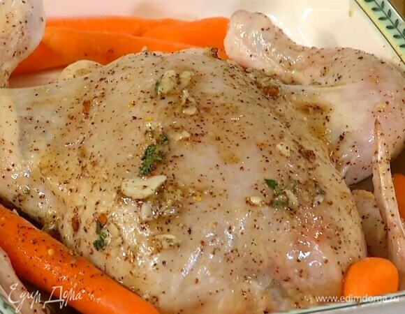 Тушку курицы поместить в жаропрочную керамическую форму грудкой вверх и кисточкой смазать медовой смесью снаружи и внутри, по бокам разложить морковь.