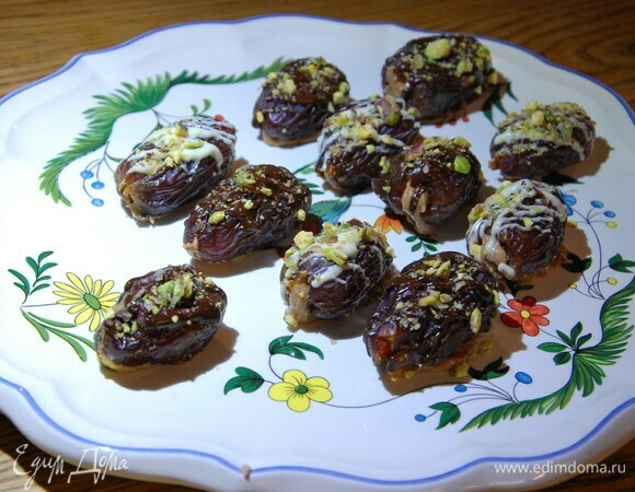 Половину фиников покрыть белым шоколадом, половину черным, посыпать фисташками и отправить в холодильник.