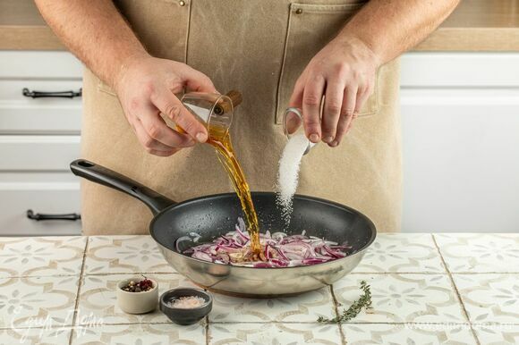 Нарежьте лук тонкими полукольцами. Разогрейте в сковороде оливковое масло, выложите лук, переведите плиту на средний уровень нагрева, томите лук до мягкости. Влейте коньяк, добавьте сахар, соль, перец и тимьян. Готовьте до испарения жидкости, помешивая, 30 минут. Дайте остыть.