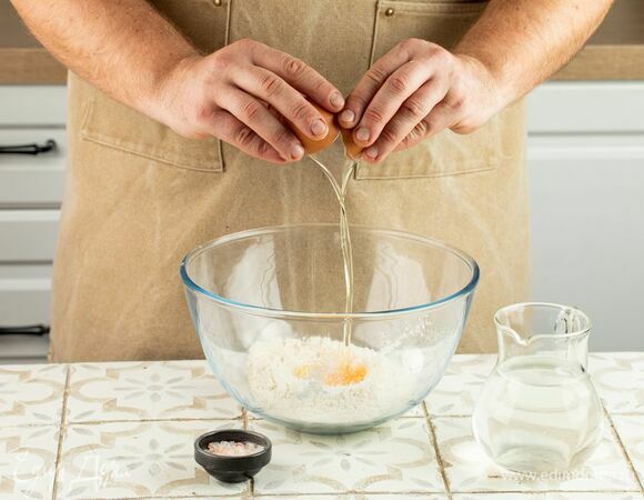 Соберите горку из муки и сделайте углубление в центре. Добавьте в муку яйцо, посолите. Тонкой струйкой влейте воду и хорошо вымесите тесто руками. Оставьте отдохнуть под полотенцем на 1 час.
