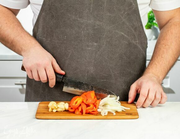 Достаньте овощи из духовки, дайте им остыть и очистите. Нарежьте перец на брусочки. Лук порубите тонкой соломкой.