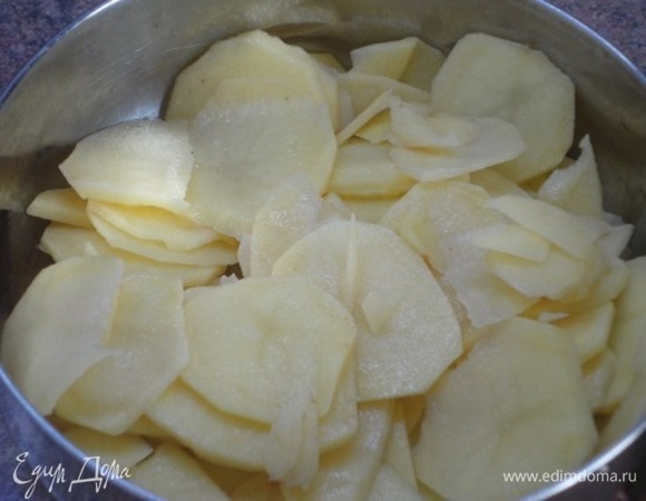 Картофель нарезать тонкими пластинками. Посолить и поперчить.