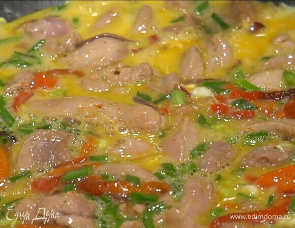 Яйца слегка взбить венчиком, влить в сковороду и аккуратно перемешать, все посолить и довести до готовности под крышкой.