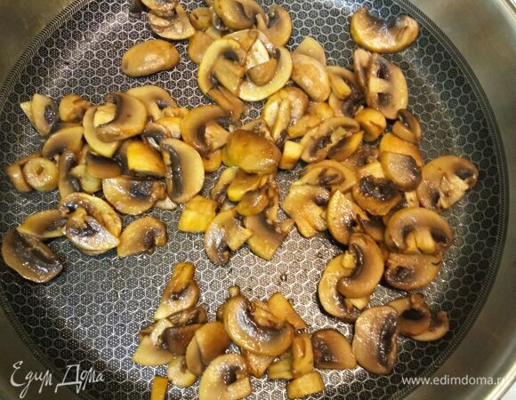 Отвариваем пасту в подсоленной кипящей воде на 1 минуту меньше, чем указано на упаковке. Промываем холодной водой. Пока паста варится, очищаем шампиньоны влажной салфеткой и режем тонкими ломтиками. Разогреваем сковороду, добавляем оливковое масло, разрезаем очищенный зубчик чеснока пополам, кладем его в разогретое масло на 1 минуту, затем вынимаем. В полученном чесночном масле обжариваем шампиньоны минут 10, если шампиньоны быстро впитают все масло, можно добавить еще немного. Следите, чтобы вся жидкость, если она образуется, выпарилась. Солим по вкусу.