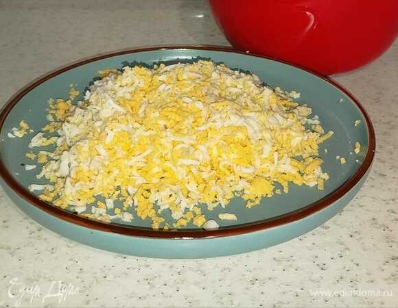Отварные яйца натереть на мелкой терке.