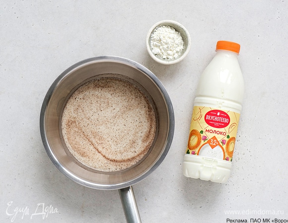 Приготовьте глазурь: в сотейник всыпьте сахарную пудру, ванильный сахар и крахмал, влейте молоко. Поставьте сотейник на огонь и готовьте, помешивая венчиком, до загустения. Снимите с огня и дайте немного остыть.