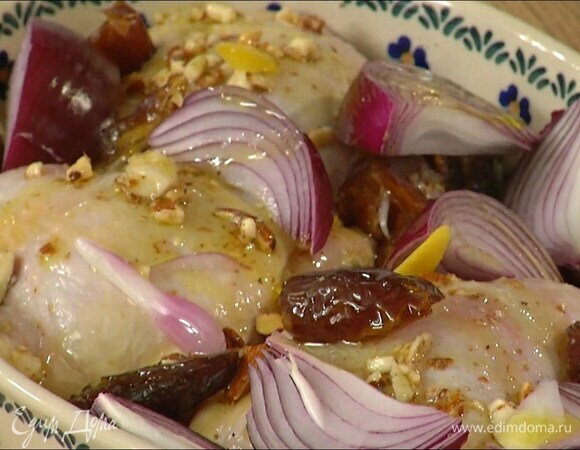 Дно жаропрочной керамической формы смазать частью измельченного с чесноком миндаля, выложить бедрышки и смазать их оставшейся ореховой массой, сверху разложить цедру лимона, красный лук и половинки фиников, сбрызнуть все оливковым маслом, посыпать черным перцем, чили и солью.