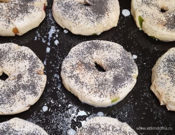 Полоски накручиваем на колечки яблок через отверстие по кругу. А вот и мой лайфхак! Одно меня вечно тормозит в их приготовлении — это просовывать тесто по кругу в кольцо яблока. И вот оно решение для тех кто торопится! Берем полоску и просто по радиусу яблока оплетаем его, в центре двумя пальцами прижимаем плотно и делаем отверстие при желание! Вуаля! Получаем вкусные, красивые булочки!<br />
<br />
Выложить заготовки на смазанный маслом противень, сверху кольца смазываем яйцом взбитым с молоком, сверху посыпать сахаром и маком. Ставим в духовку при 180-200 °C до золотистого цвета.