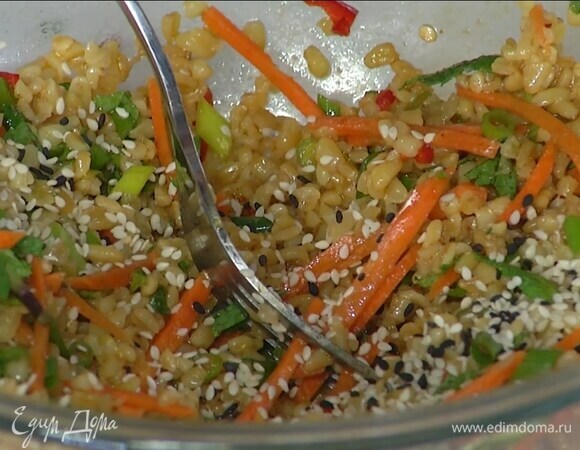 Булгур перемешать вилкой, добавить морковь, нарезанную зелень, полить заправкой, посолить, добавить чили, кунжут и все перемешать.