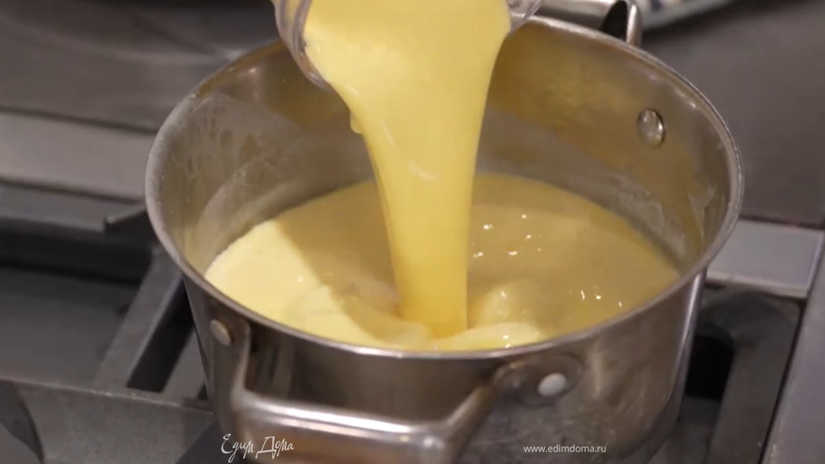 Удалить из сливочно-молочной смеси цедру лимона, часть молока влить в желтки и все взбить, затем вылить желтковую массу обратно в кастрюлю со сливками и молоком.