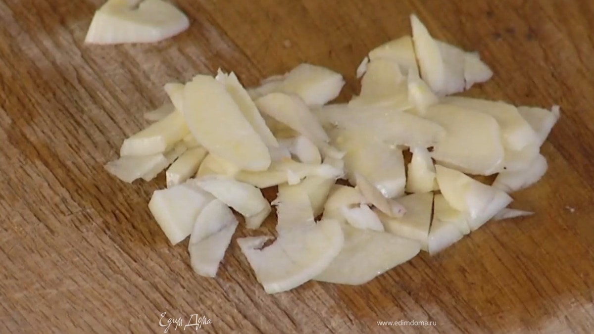 Чеснок почистить, нарезать небольшими кусочками и добавить к луку.