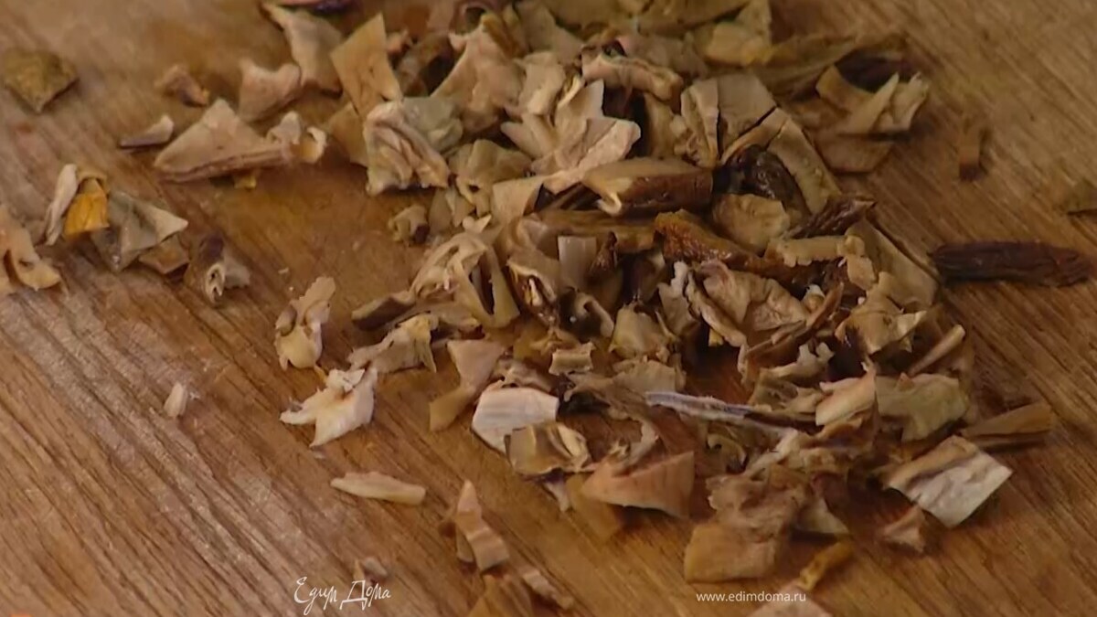 Воду из замоченных грибов слить и сохранить, грибы промыть, просушить бумажным полотенцем и мелко порезать.
