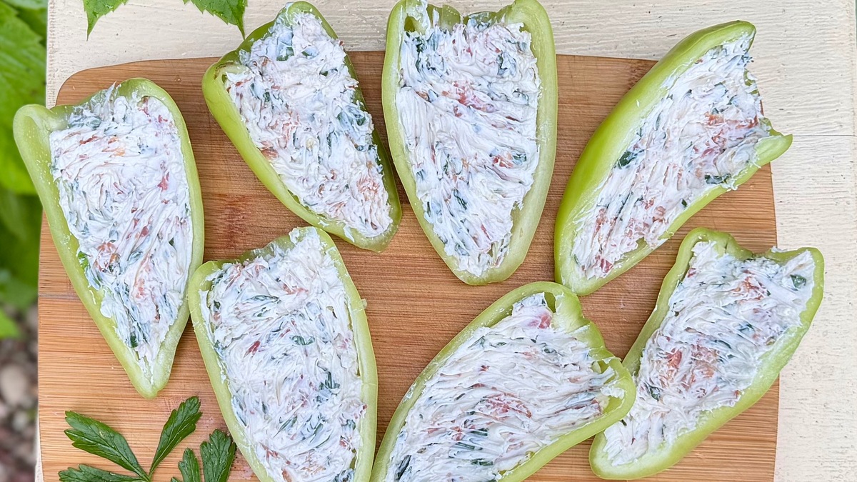 Наполните перцы начинкой (без горки). Запекайте в духовке по температуре 180 градусов 12 минут. Достаньте перцы, посыпьте тертым сыром и запекайте еще 3 минуты.